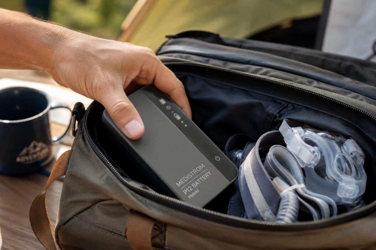 Packing a Medistrom CPAP battery and CPAP mask into a travel bag before a camping trip