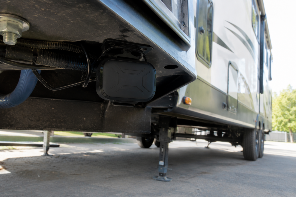 GPS tracker for travel trailer mounted under the trailer frame near the hitch