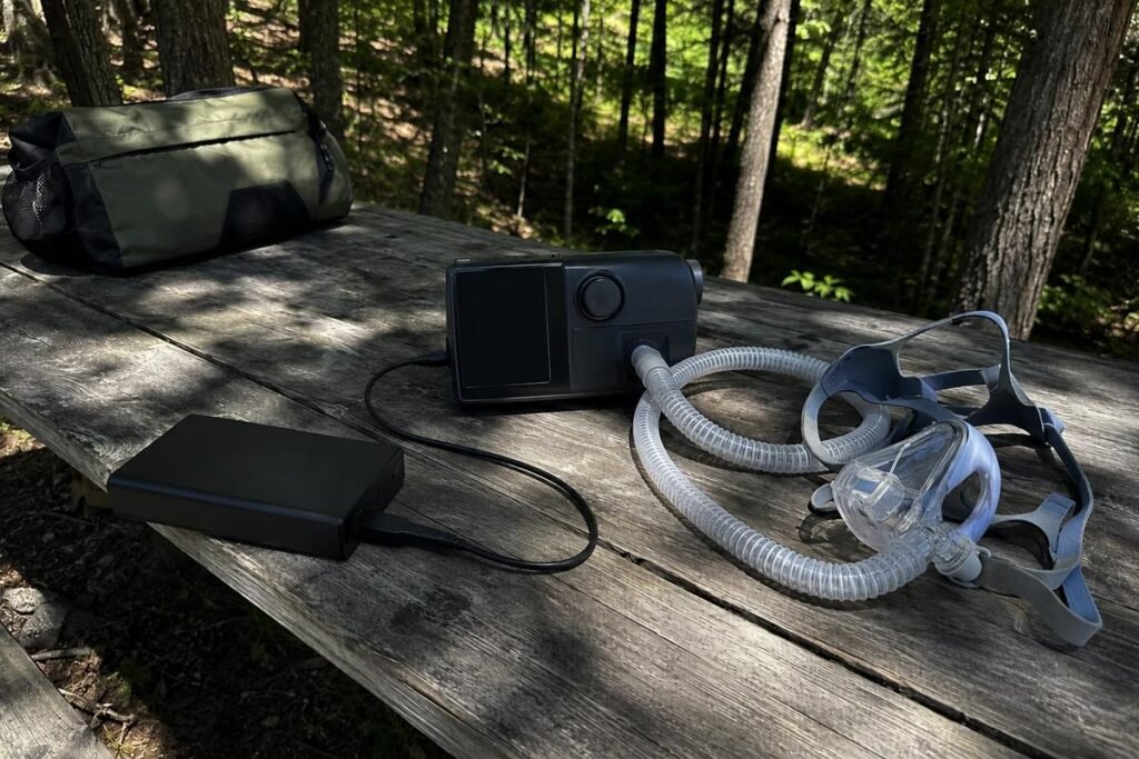 CPAP battery pack on a picnic table at a campsite