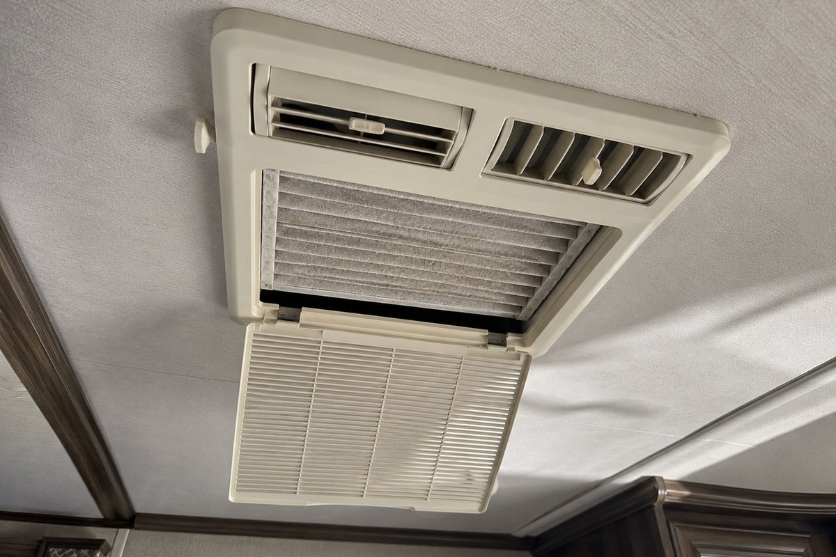 RV ceiling air distribution box with the return air grille open, checked when an RV thermostat is suspected